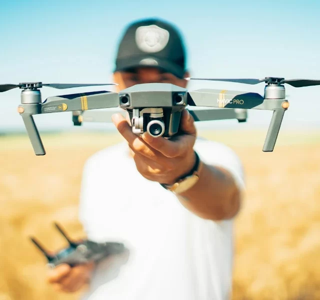 person-holding-a-drone-in-a-field